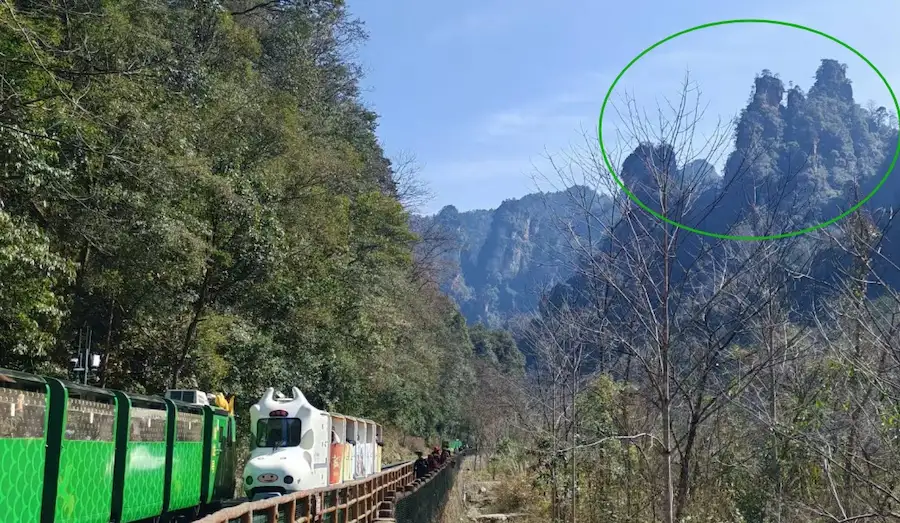 A couple holding their child at the Ten-Mile Gallery in Zhangjiajie
