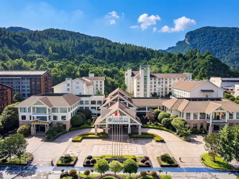 Pullman Zhangjiajie Hotel exterior with Wulingyuan karst peaks at sunset