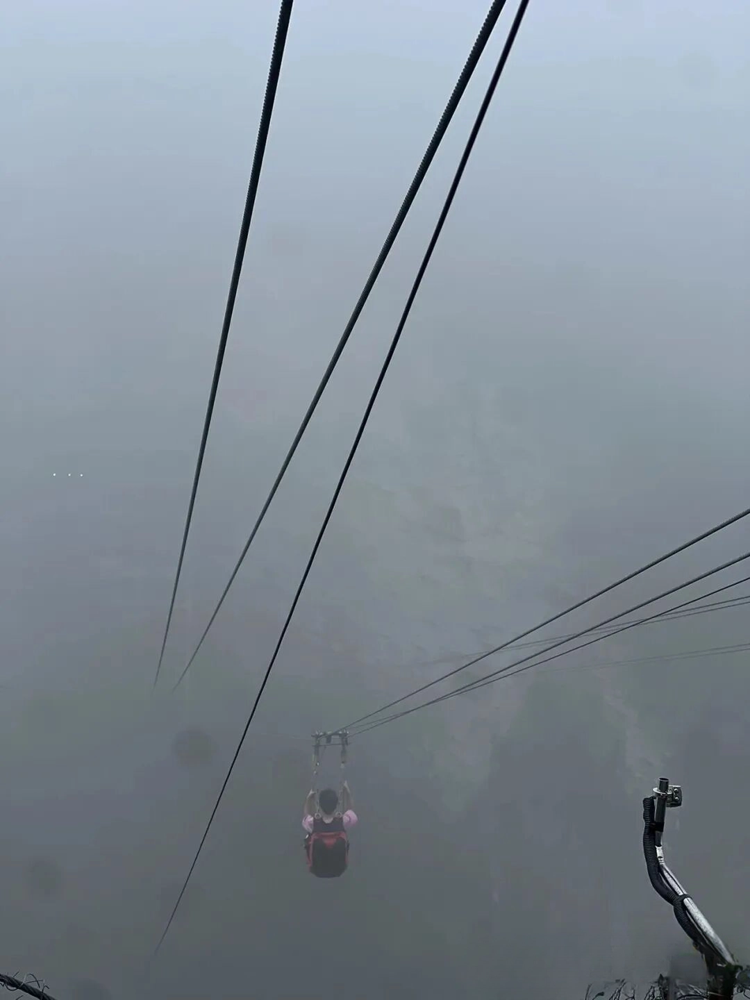 Tourist riding the Zhangjiajie zipline over the Grand Canyon